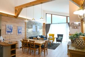 a dining room and living room with a table and chairs at Villa Raphael w Jacuzzi near Pirin Golf Resort in Bansko