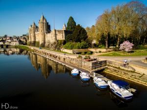 a group of boats docked in the water in front of a castle at TI WAR AN DOUR in Guégon