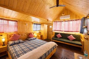 a bedroom with a bed and a couch in a room at Sierra Vista Resort in Nashik