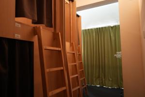 a room with two bunk beds and a window at Santiago Guesthouse Kyoto in Kyoto +24 photos