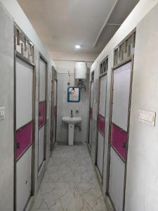 a small bathroom with a sink and a toilet at Agrasen Homestay in Prayagraj +4 photos