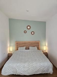 a bedroom with a large bed with two lamps at La Casa Delviga in Olivella +21 photos