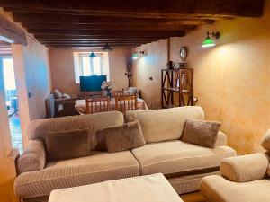 a living room with a couch and a table at Navas de Lema in Las Navas de Buitrago
