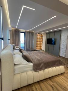 a large bedroom with a large bed and a television at Villa Xika in Sarandë
