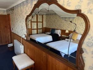 a bedroom with two beds and a large mirror at Navas de Lema in Las Navas de Buitrago