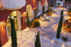 an overhead view of a courtyard with chairs and trees at Hotel Royalmar in Cagnes-sur-Mer