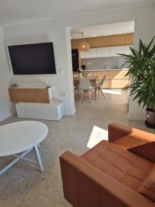 a living room with a couch and a table at Green River Apartment in Stahovica