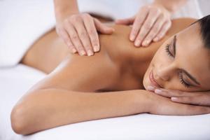 a woman getting a back massage in a spa at Ranmore Rise Retreat in the Surrey Hills in Dorking