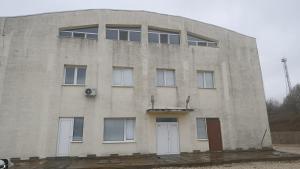 a large brick building with a white door at стаи за настаняване in Razgrad