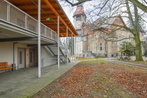 a building with a staircase and a building with a clock tower at Villa Ephraim in Görlitz