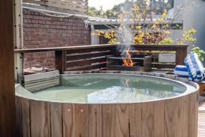a hot tub with a fire in a backyard at Camps Bay Village in Cape Town