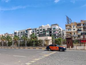 a car parked on the side of a street with buildings at Red Sea Downtown in Hurghada