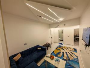 a living room with a blue couch and a table at Red Sea Downtown in Hurghada