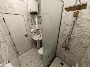 a bathroom with a shower and a toilet and a sink at Red Sea Downtown in Hurghada +16 photos