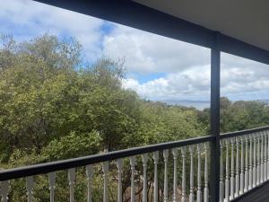 a balcony with a view of trees and water at Pillais B and B in Albany +11 photos