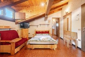 a bedroom with a bed and a couch in a room at Rifugio del Sole Apartment in Monclassico +29 photos