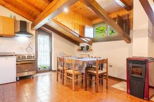 a kitchen with a table and chairs in a room at Rifugio del Sole Apartment in Monclassico