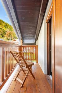 a wooden porch with a bench on a deck at Rifugio del Sole Apartment in Monclassico