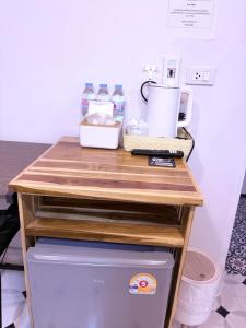 a wooden counter top on top of a refrigerator at Pion Hotel Ayutthaya in Phra Nakhon Si Ayutthaya