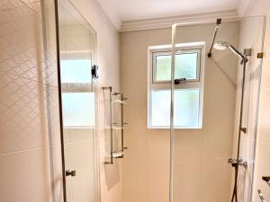 a bathroom with a shower and a window at Villa Sunny Side in Mellieħa +25 photos