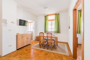 a kitchen and dining room with a table and chairs at Apartments Rombon Klavdij with Free Onsite Parking in Bovec