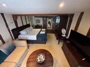 an aerial view of a bedroom with a bed and a couch at Sams Wine Bar Harwich ltd in Harwich
