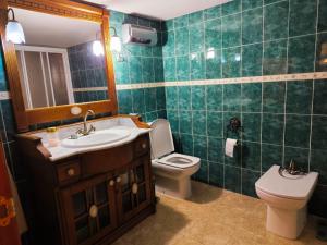 a bathroom with a sink and a toilet and a mirror at Navas de Lema in Las Navas de Buitrago +18 photos