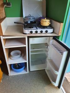 a toy kitchen with a stove and dishes in it at De Maanloper in Bant