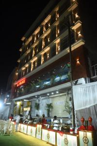 a restaurant in front of a building at night at LL Palace in Hinganghāt