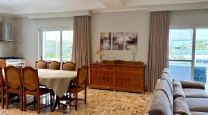 a kitchen and dining room with a table and a couch at Villa Sunny Side in Mellieħa