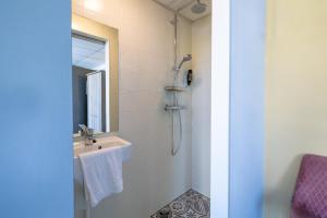 a bathroom with a sink and a mirror at Strandhotel Wemeldinge in Wemeldinge +22 photos