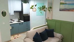 a living room with a couch and a kitchen at La Casa De Mi Madre - 2 bed flat in the heart of Torrevieja in Torrevieja