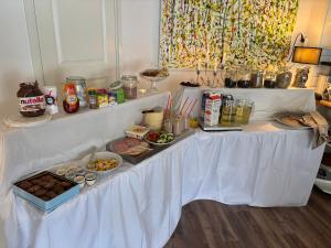 a white table with food and drinks on it at Studio Ranch Johanna in Kullavik