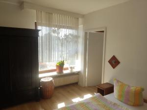 a bedroom with a bed and a window with a plant at Unterkunft Mau in Rotenburg an der Wümme +13 photos