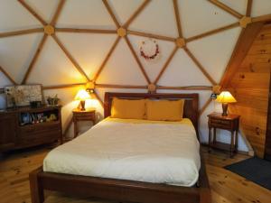a bedroom with a large bed in a room at Mush's rooms in Saint-Julien-Labrousse