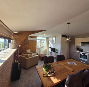 a dining room and living room with a wooden table at Molesicht en Lânsicht in Workum +21 photos