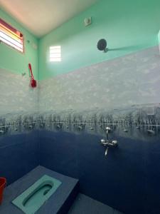 a bathroom with a toilet in the middle of the room at STAR Residency - G in Pondicherry
