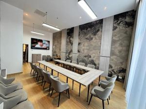 a conference room with a long table and chairs at ARIS Boutique Hotel & SPA in Oradea +161 photos
