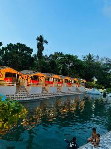 a pool at a resort with people in the water at Tuburan Resort in Panong
