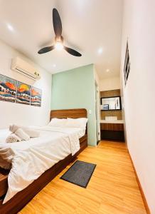 a bedroom with two beds and a ceiling fan at Happy House in Danang