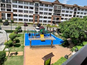 an empty playground in front of a large building at One Oasis Condo beside SM Mall in Davao City