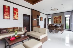 a living room with a couch and a table at The Best Ao Nang Villas in Ao Nang Beach