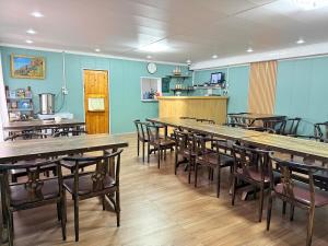 a large dining room with tables and chairs at MONKHSUURI GUESTHOUSE in Harhorin