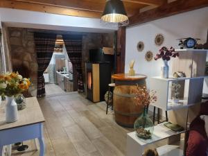 a room with a barrel and vases on shelves at CASA La Playeta in Puente de Vadillos +32 photos