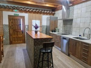 a kitchen with a wooden counter and a sink at CASA La Playeta in Puente de Vadillos