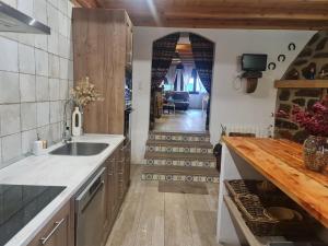 a kitchen with a sink and a counter top at CASA La Playeta in Puente de Vadillos