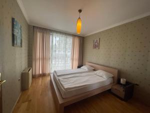 a bedroom with a white bed and a window at ApartComplex Splendid in Saints Constantine and Helena +50 photos