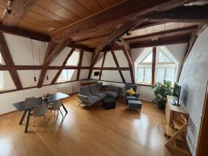 a large living room with wooden ceilings and a table at Irseer Hof in Hagnau in Hagnau