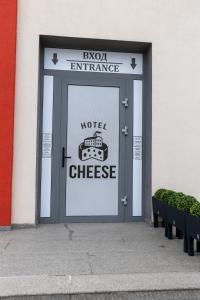 a door in a building with a sign on it at Hotel Cheese in Shumen