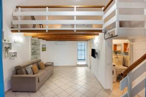a living room with a couch and a staircase at La Volta Amalfi Coast in Furore